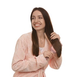 Photo of Smiling woman brushing her hair on white background