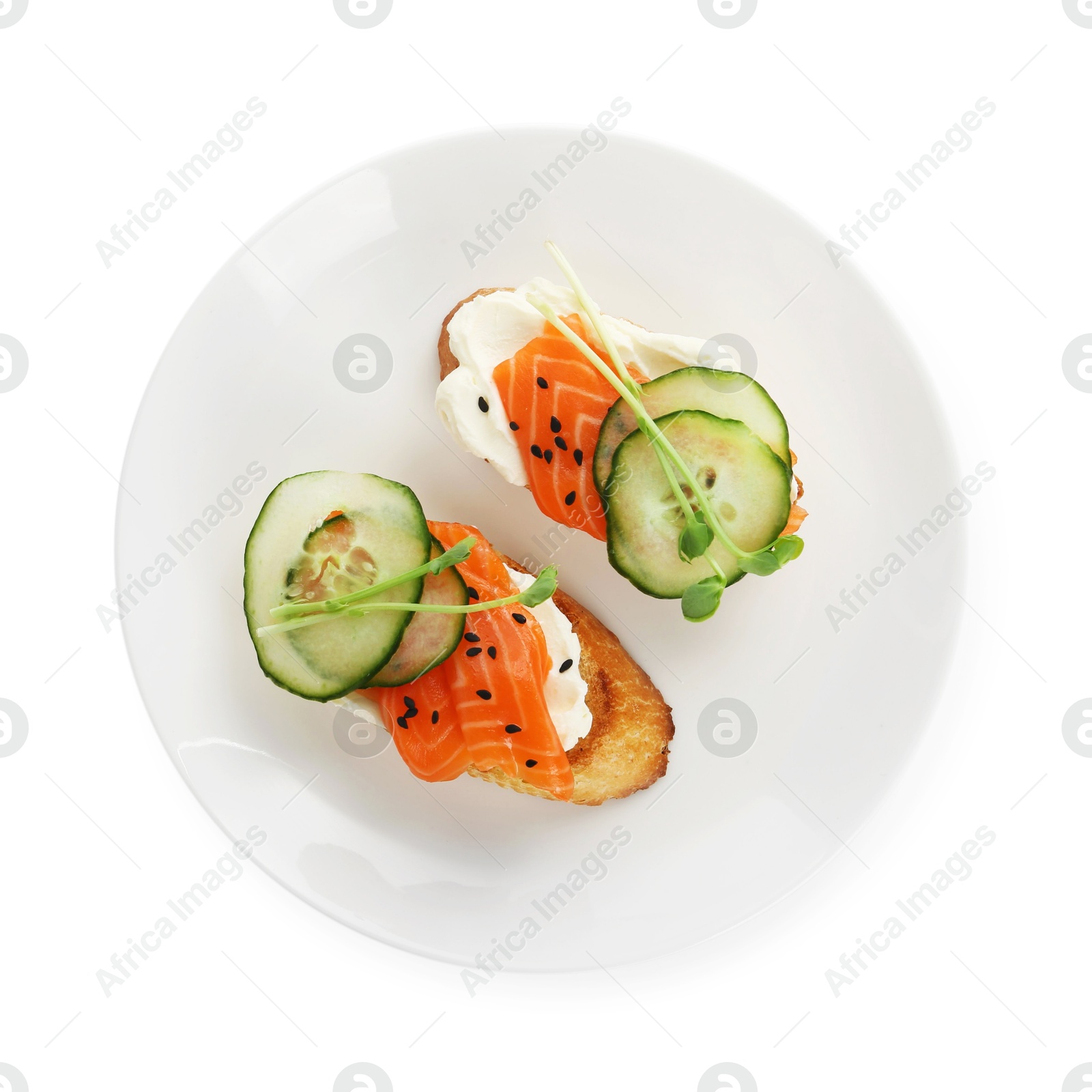 Photo of Delicious bruschette with cream cheese, salmon and cucumber isolated on white, top view