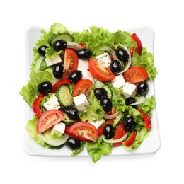 Photo of Delicious fresh Greek salad isolated on white, top view