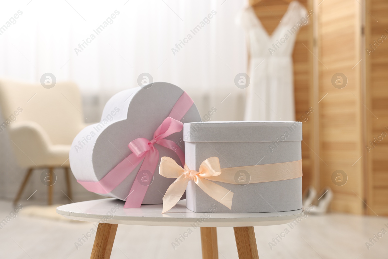 Photo of Different gift boxes on white table indoors