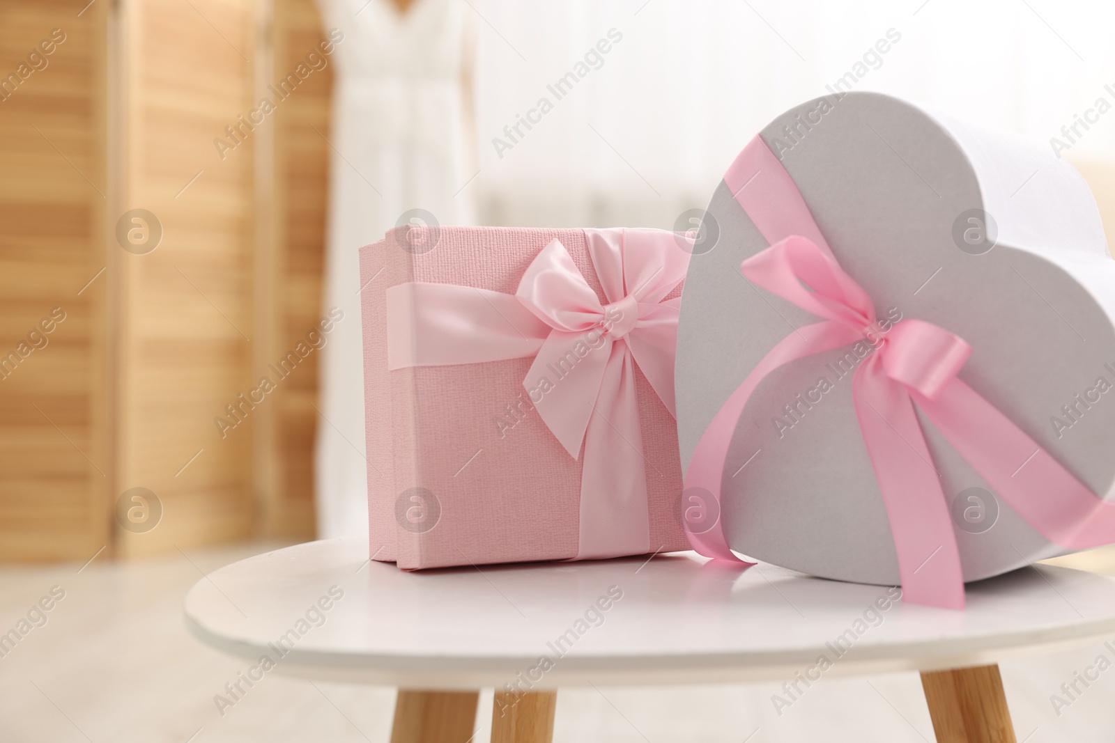 Photo of Gift boxes for wedding day on white table indoors, space for text