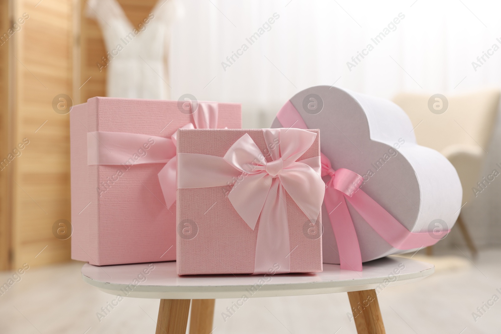 Photo of Different gift boxes on white table indoors