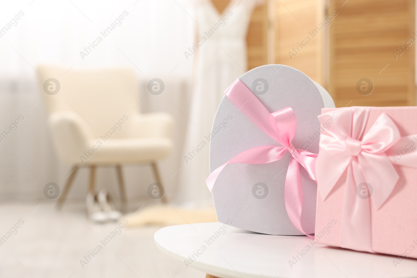 Photo of Gift boxes for wedding day on white table indoors, space for text