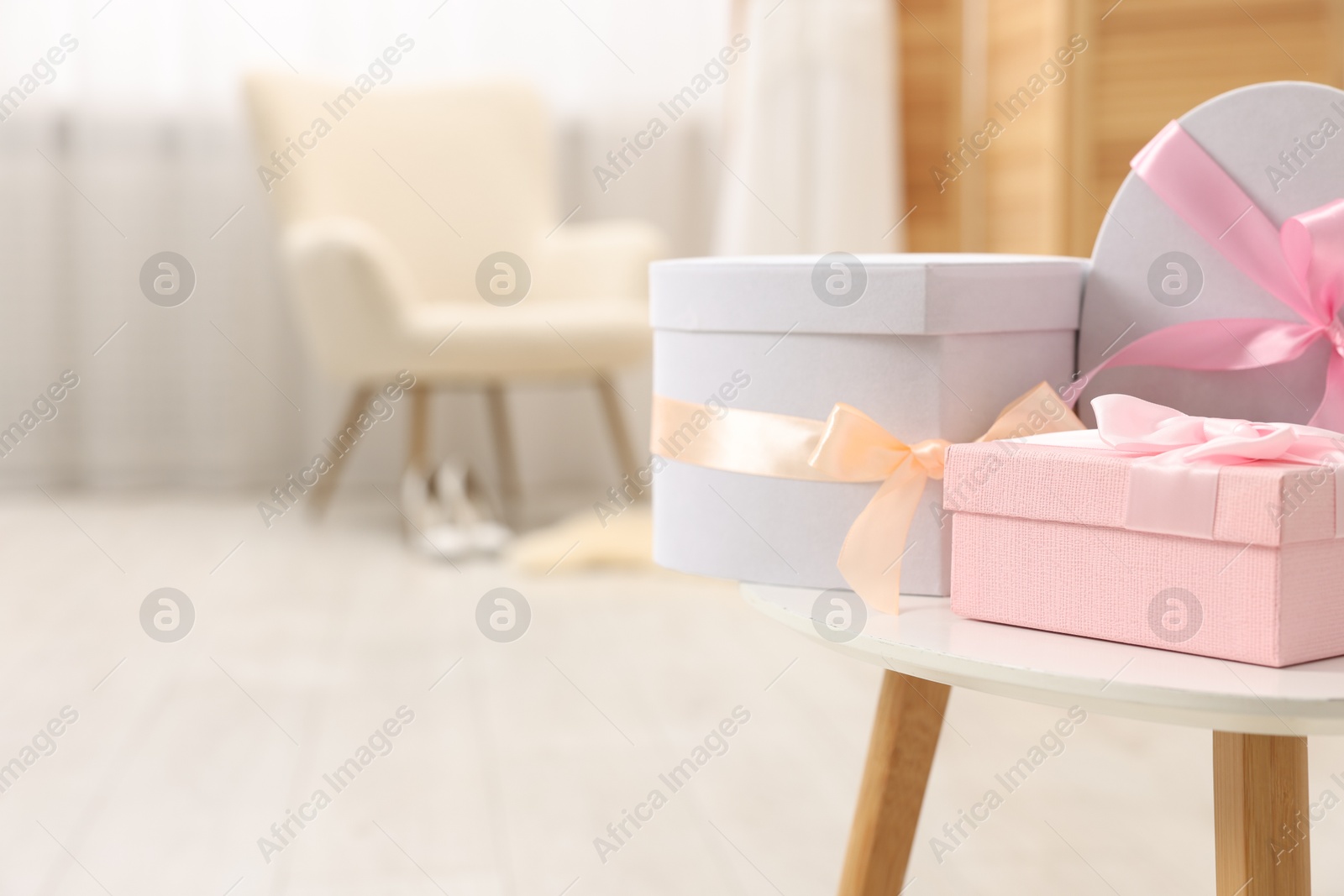 Photo of Gift boxes for wedding day on white table indoors, space for text