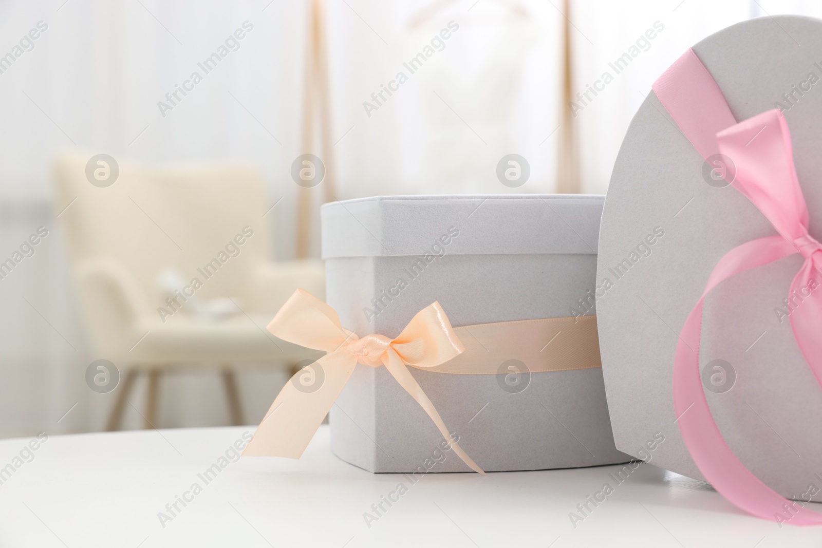 Photo of Gift boxes for wedding day on white table indoors, closeup. Space for text