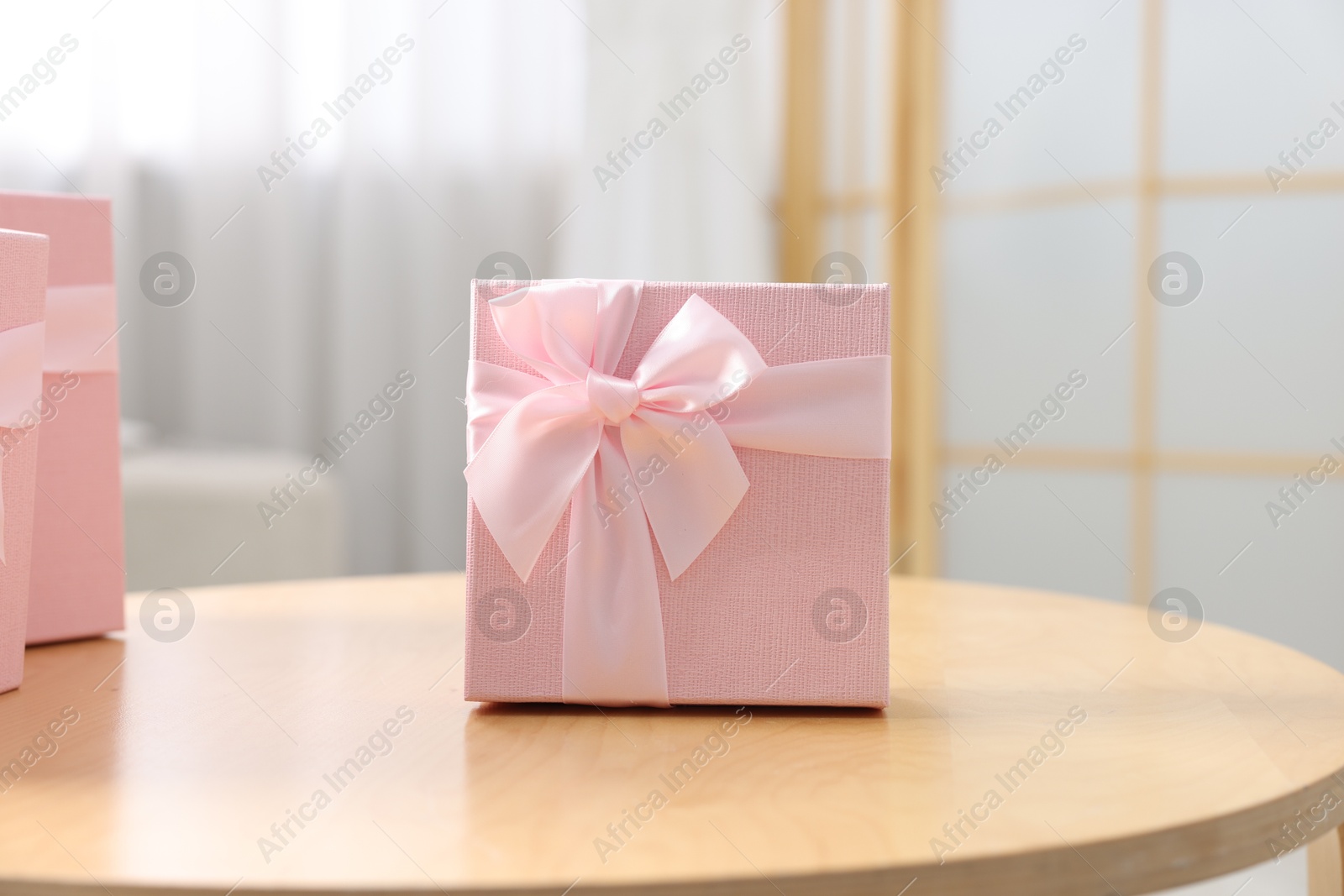 Photo of Gift boxes for wedding day on wooden table indoors