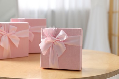 Photo of Gift boxes for wedding day on wooden table indoors