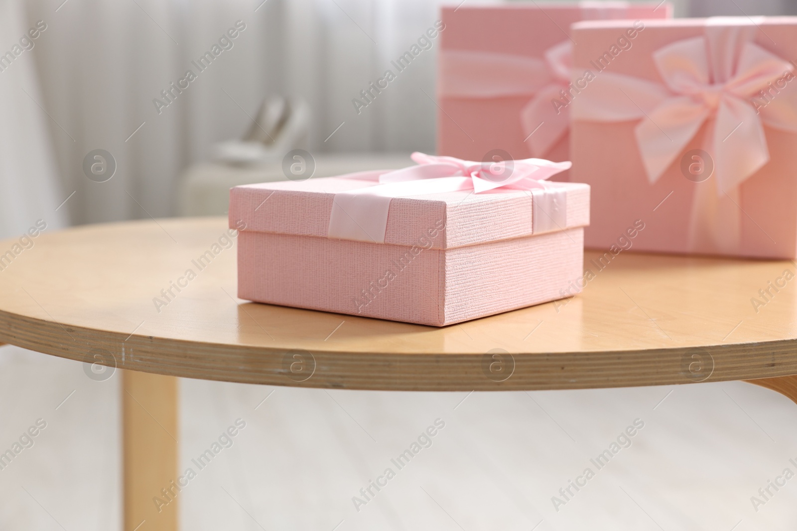 Photo of Gift boxes for wedding day on wooden table indoors