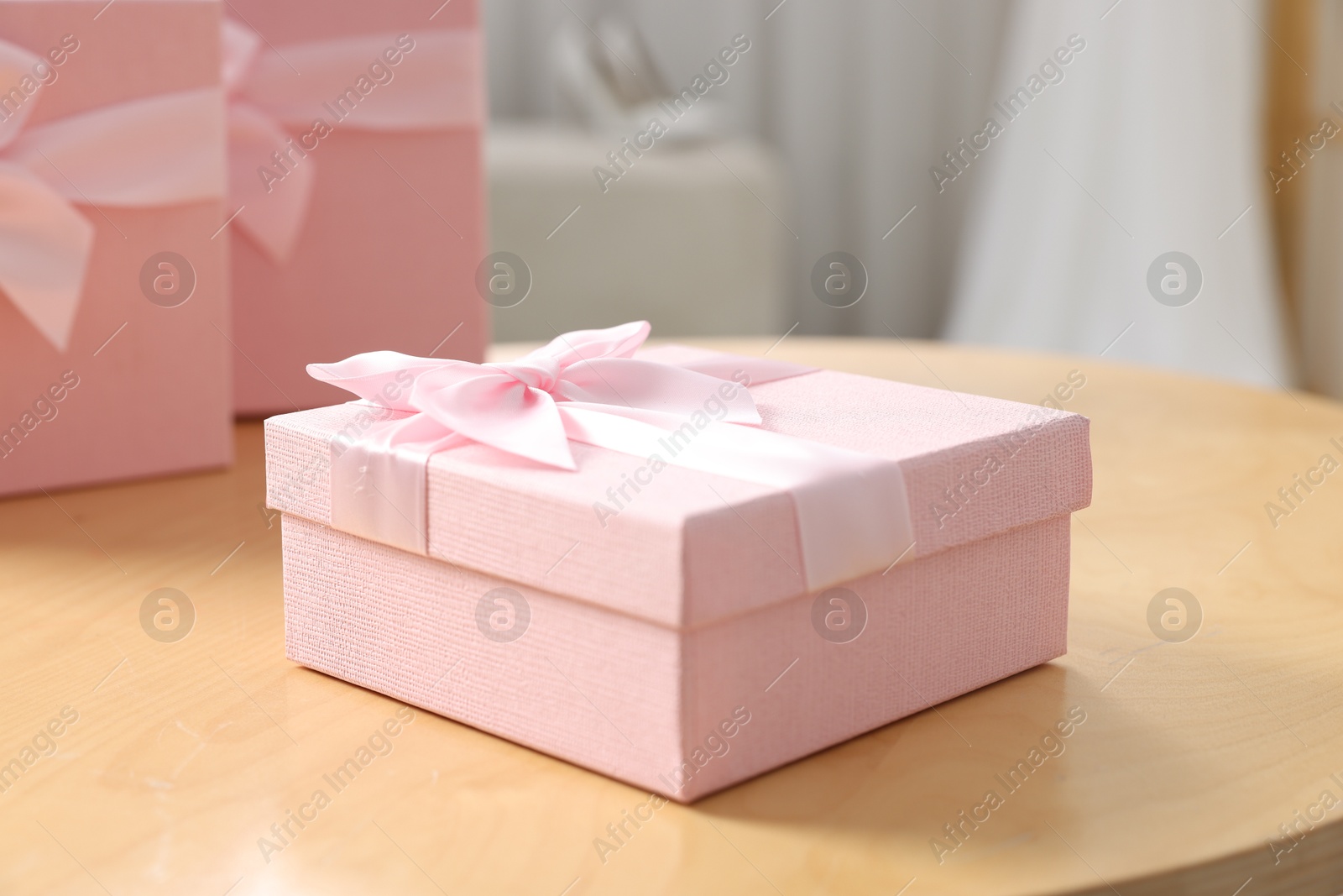 Photo of Gift boxes for wedding day on wooden table indoors, closeup