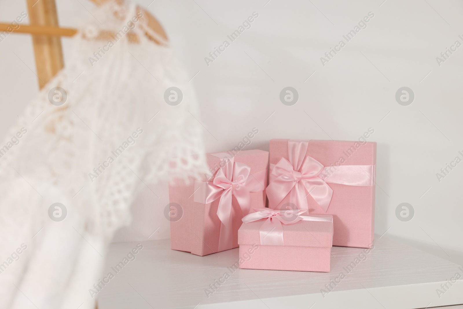 Photo of Gift boxes for wedding day on white wooden table