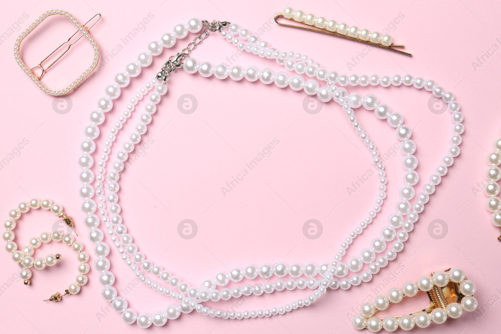 Photo of Stylish accessories on light pink background, flat lay. Space for text