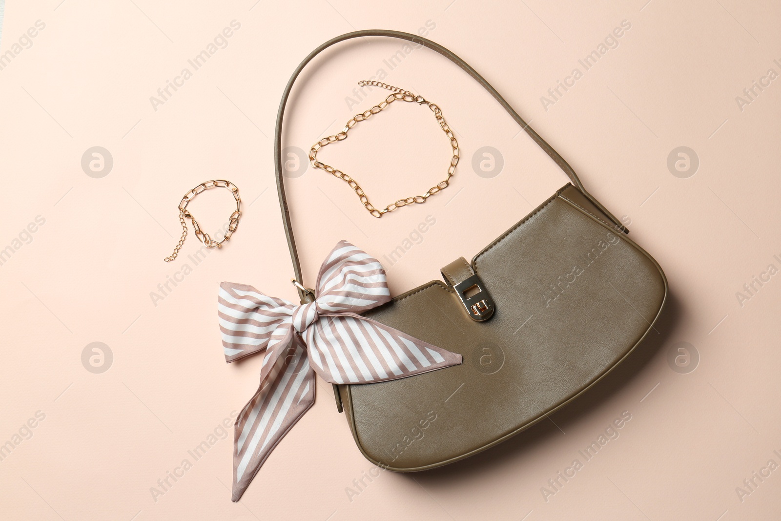 Photo of Beautiful bag and stylish accessories on beige background, flat lay