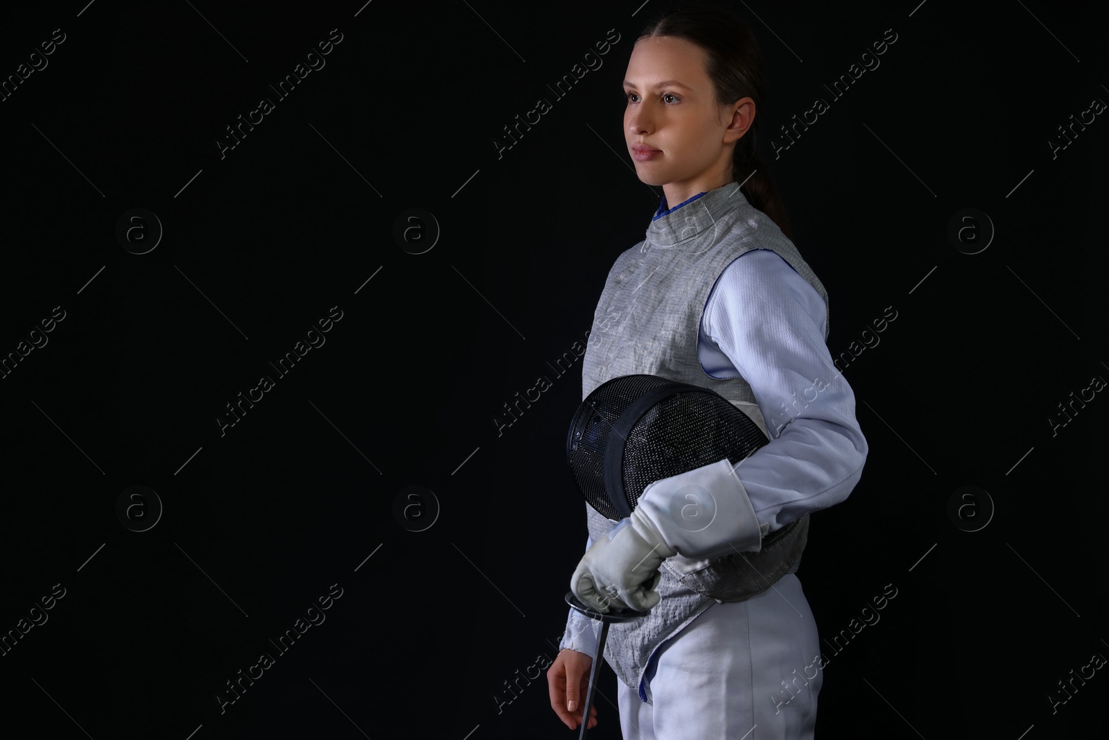 Photo of Fencer with epee on black background, space for text