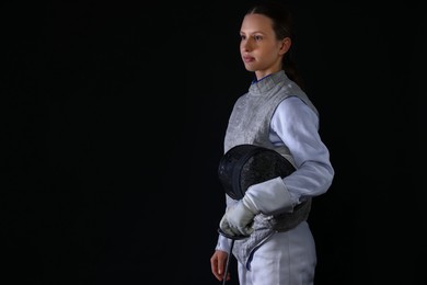 Photo of Fencer with epee on black background, space for text