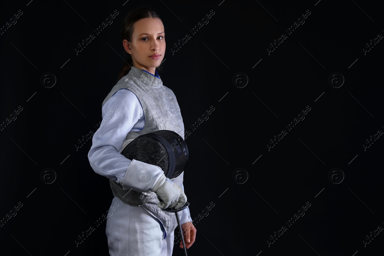 Photo of Fencer with epee on black background, space for text