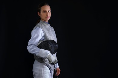 Photo of Fencer with epee on black background, space for text