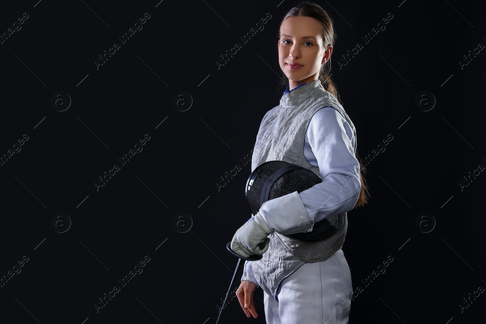 Photo of Fencer with epee on black background, space for text