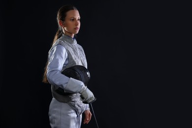 Photo of Fencer with epee on black background, space for text