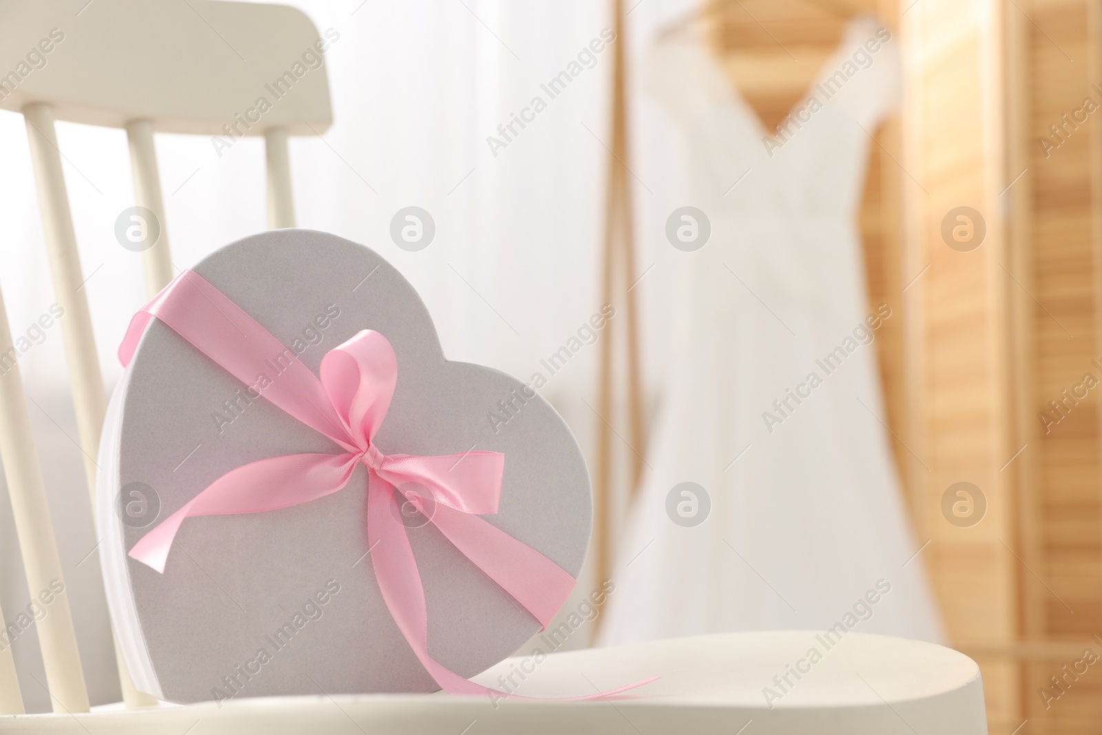 Photo of Gift box for wedding day on chair indoors, space for text