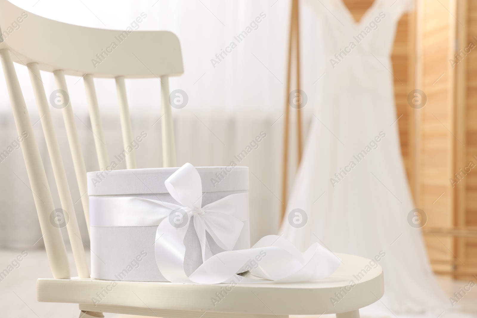 Photo of Gift box for wedding day on chair indoors, space for text