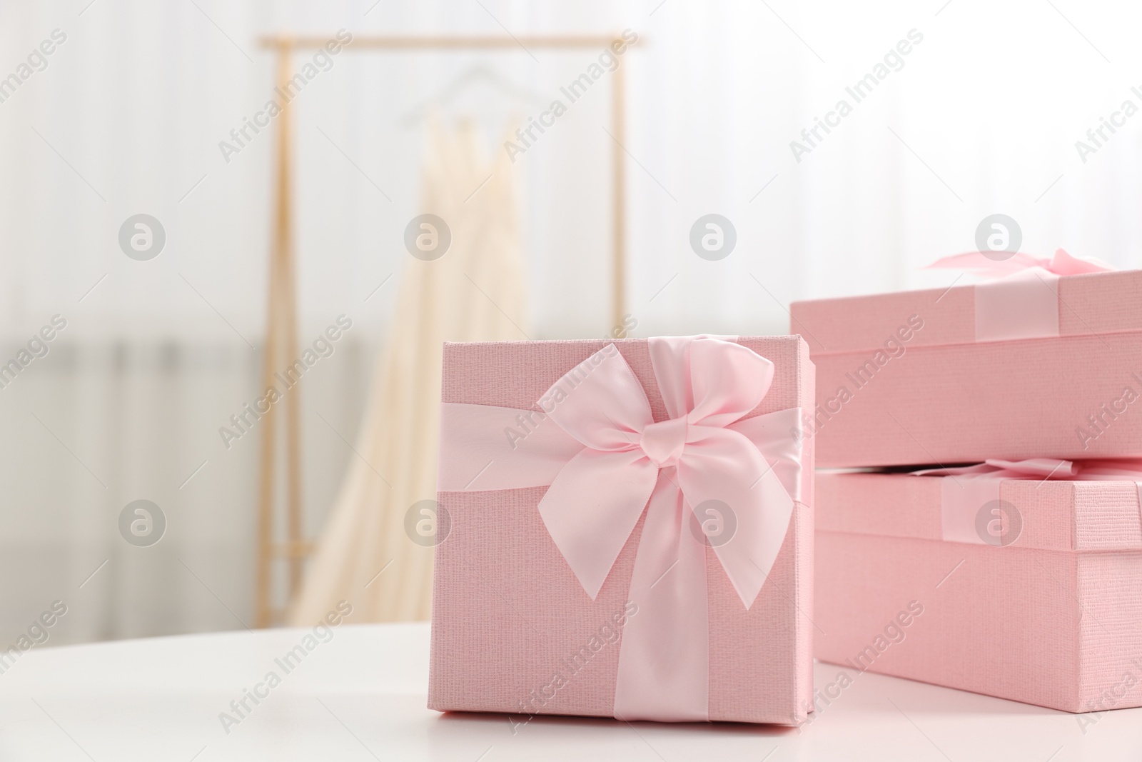 Photo of Gift boxes for wedding day on white table indoors, space for text