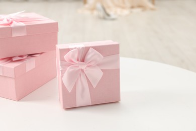 Photo of Gift boxes for wedding day on white table indoors, closeup. Space for text