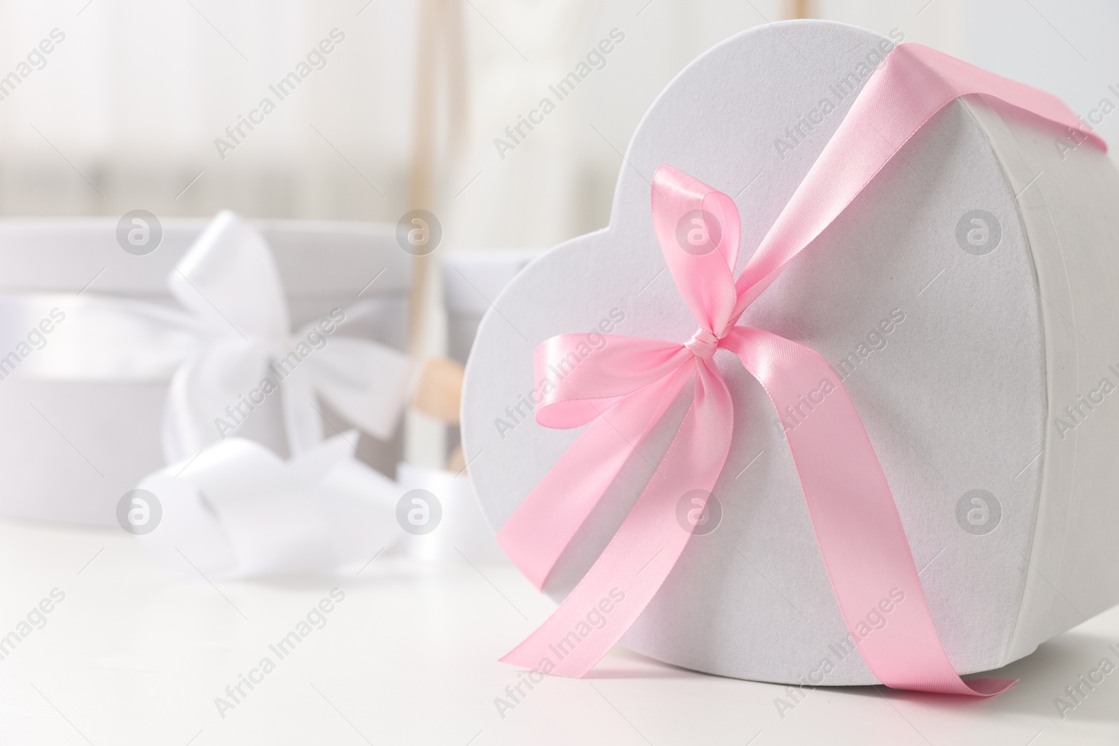 Photo of Gift boxes for wedding day on white table indoors, closeup. Space for text