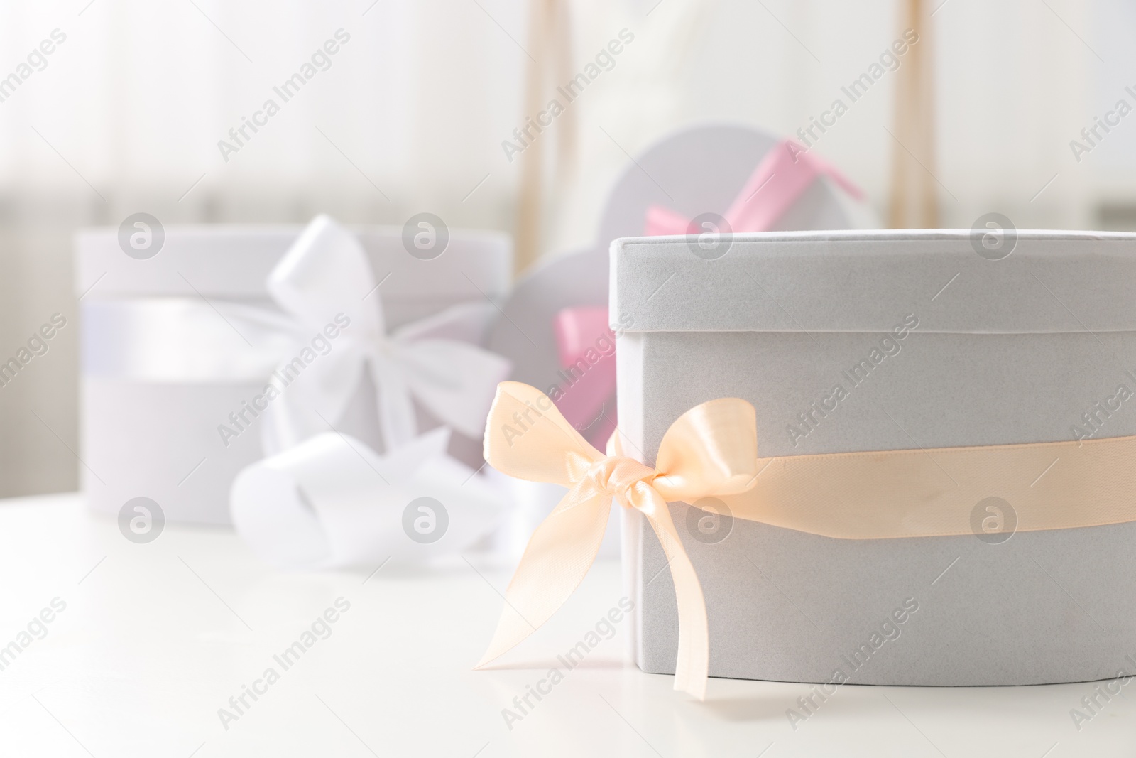 Photo of Gift boxes for wedding day on white table indoors, closeup. Space for text