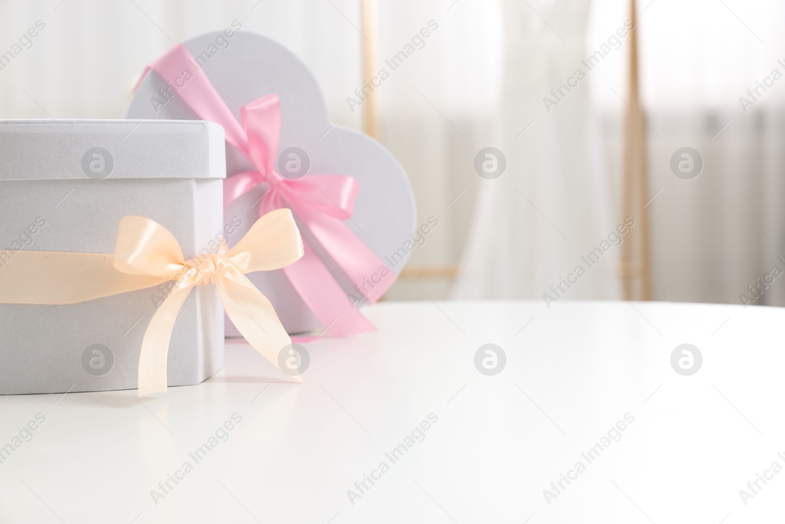 Photo of Gift boxes for wedding day on white table indoors, space for text