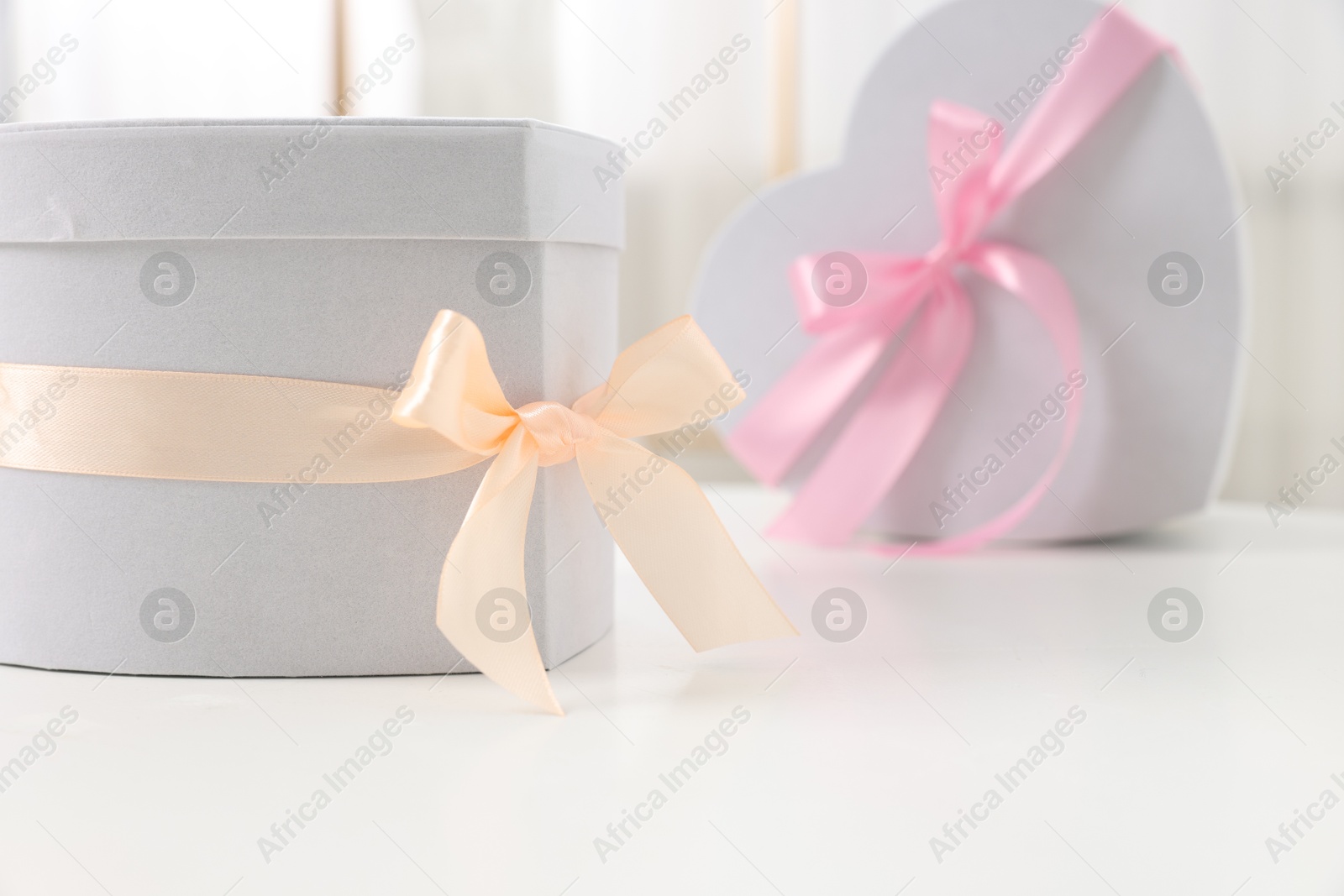 Photo of Gift boxes for wedding day on white table indoors, space for text