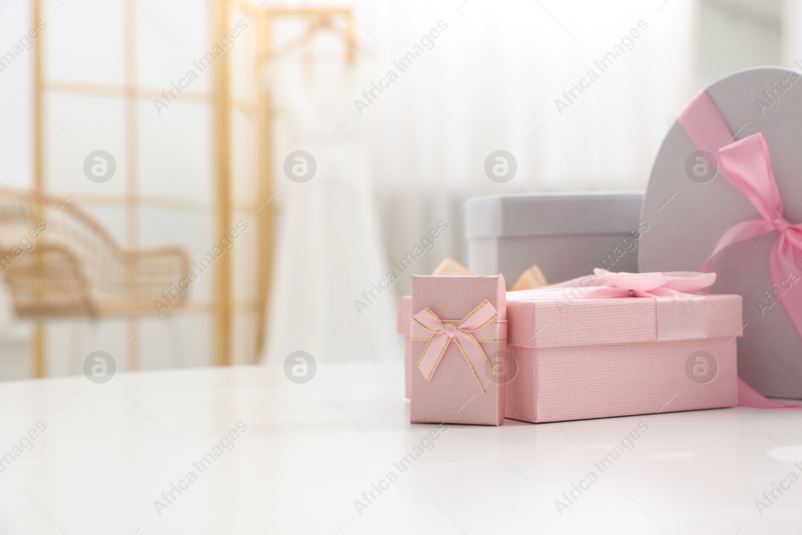 Photo of Gift boxes for wedding day on white table indoors, space for text