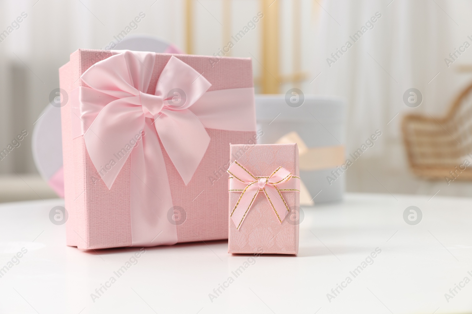 Photo of Gift boxes for wedding day on white table indoors, space for text