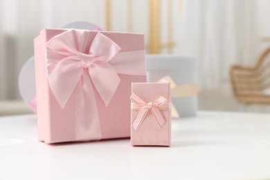 Photo of Gift boxes for wedding day on white table indoors, space for text