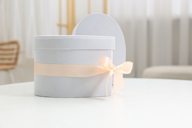 Photo of Gift boxes for wedding day on white table indoors, space for text