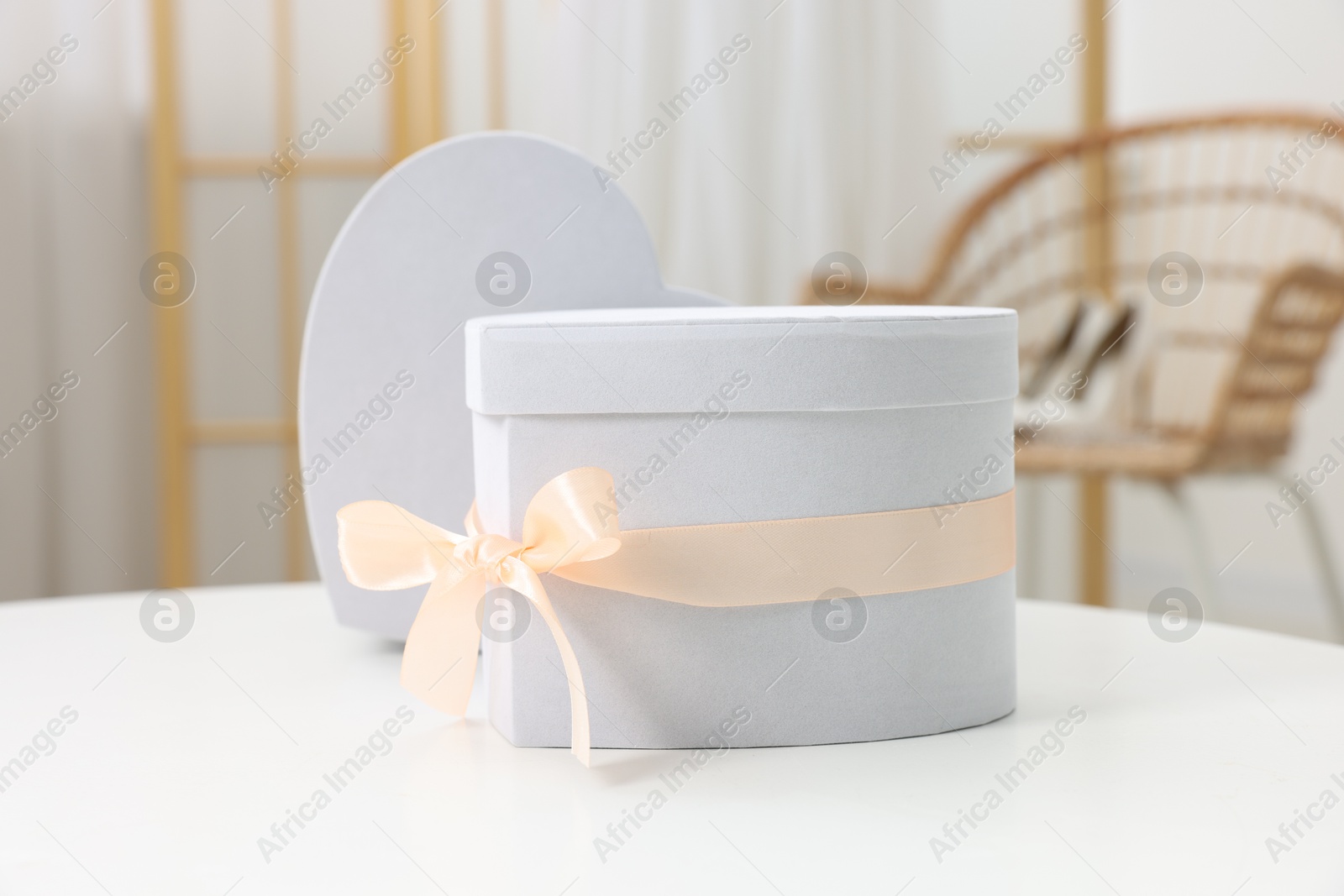 Photo of Two gift boxes on white table indoors