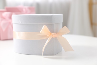 Photo of Gift box for wedding day on white table indoors, closeup. Space for text