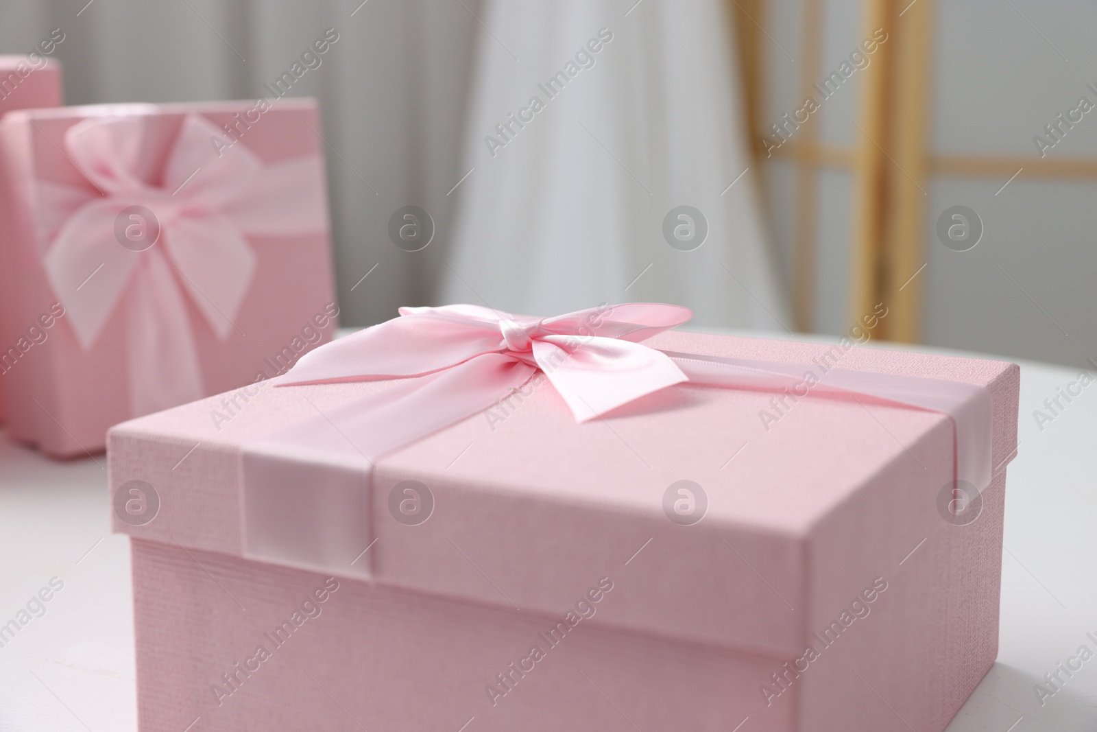 Photo of Gift boxes for wedding day on white table indoors, closeup