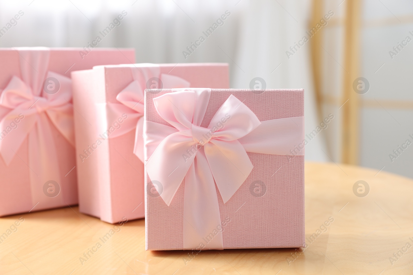 Photo of Gift boxes for wedding day on wooden table indoors, closeup