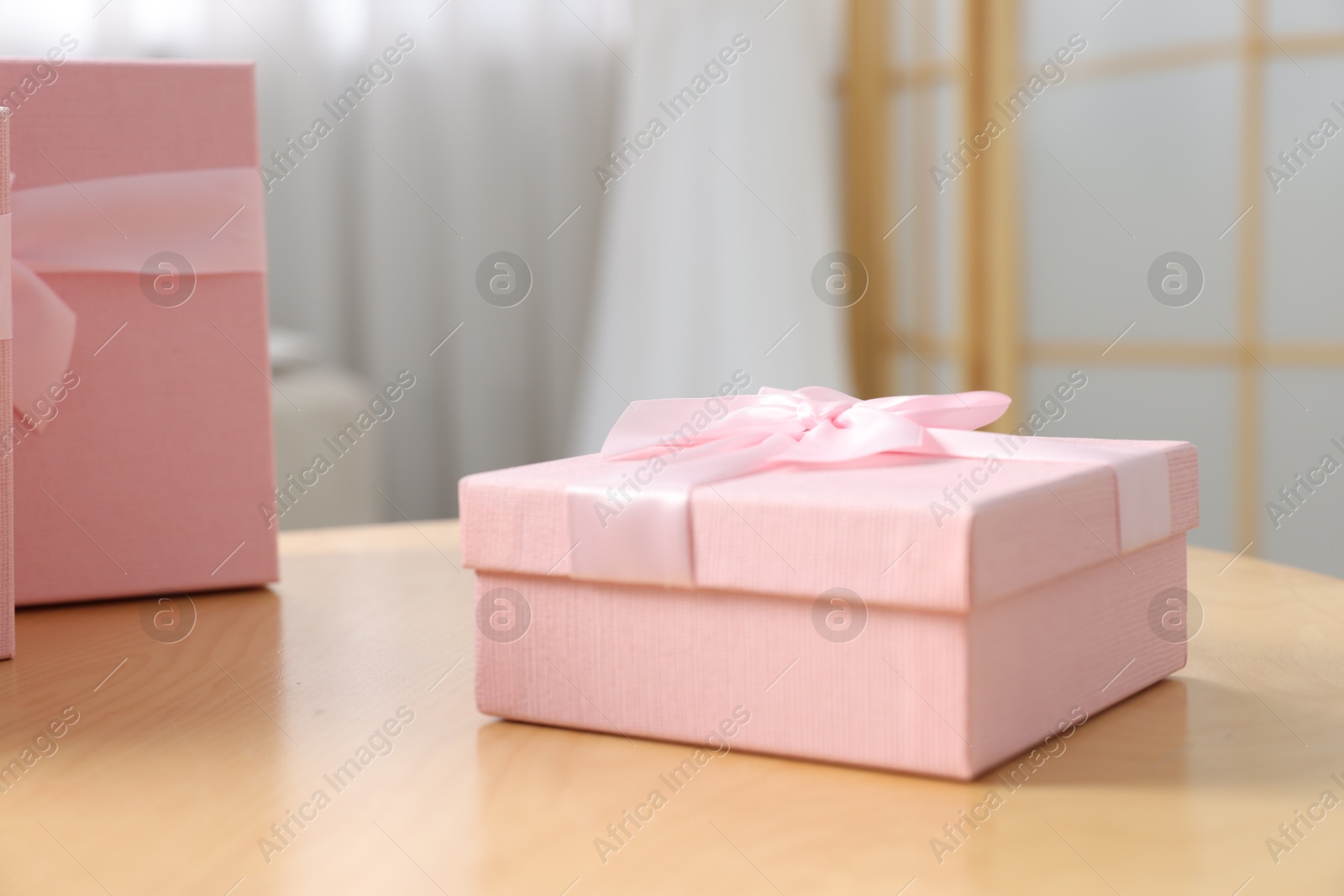 Photo of Gift boxes for wedding day on wooden table indoors