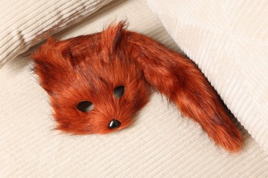 Photo of Quadrobics. Fox mask and tail on sofa, above view