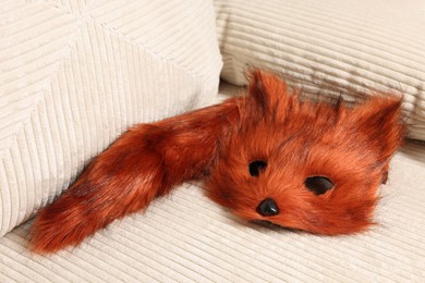 Photo of Quadrobics. Fox mask and tail on sofa