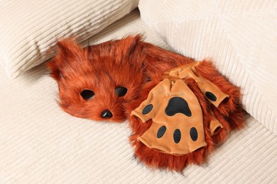 Photo of Quadrobics. Fox mask, gloves and tail on sofa