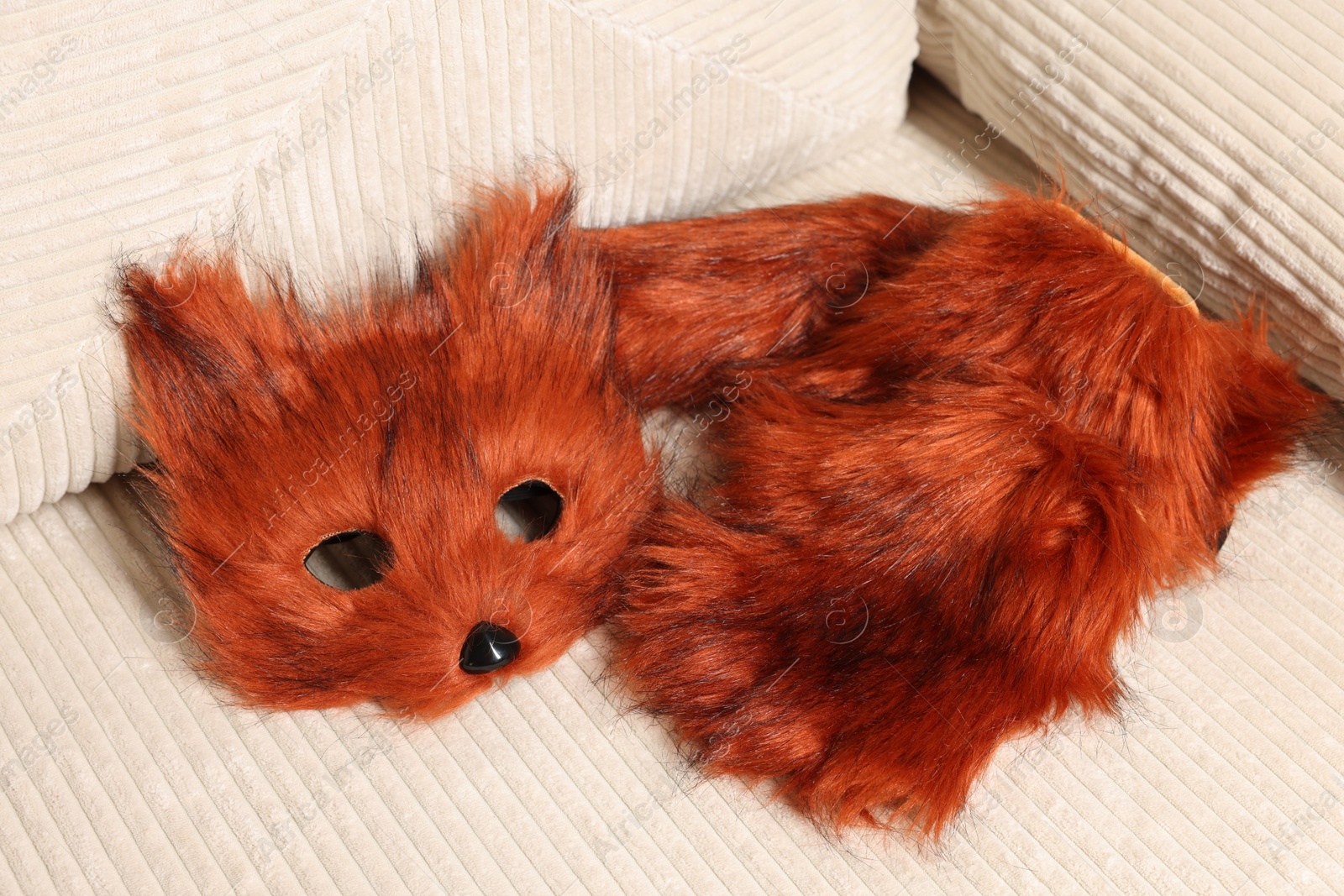 Photo of Quadrobics. Fox mask, gloves and tail on sofa