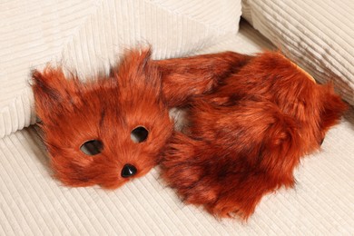 Photo of Quadrobics. Fox mask, gloves and tail on sofa