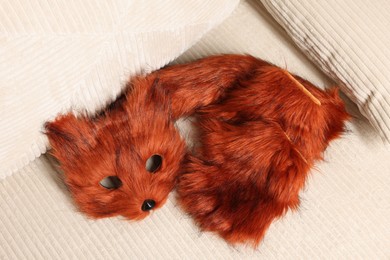 Photo of Quadrobics. Fox mask, gloves and tail on sofa, top view