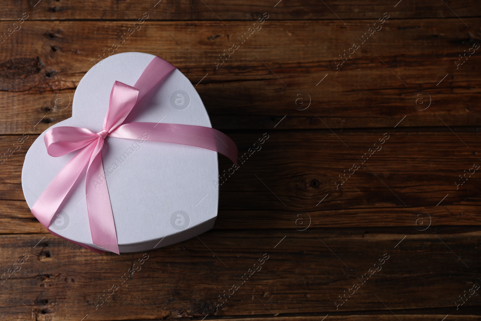 Photo of Gift box for wedding day on wooden background, top view. Space for text