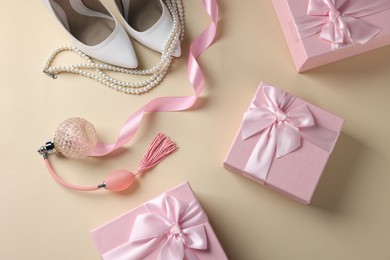 Photo of Flat lay composition with gift boxes for wedding day on beige background