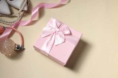 Photo of Flat lay composition with gift box for wedding day on beige background. Space for text