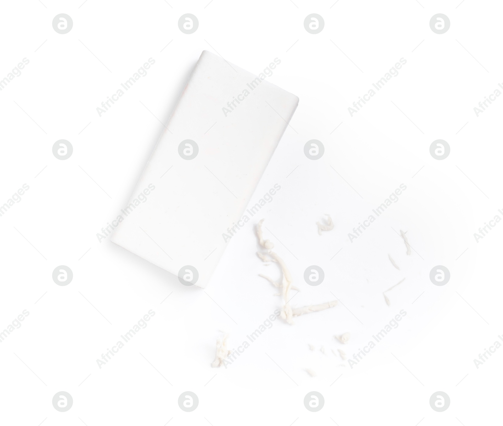 Photo of One eraser and scraps isolated on white, top view