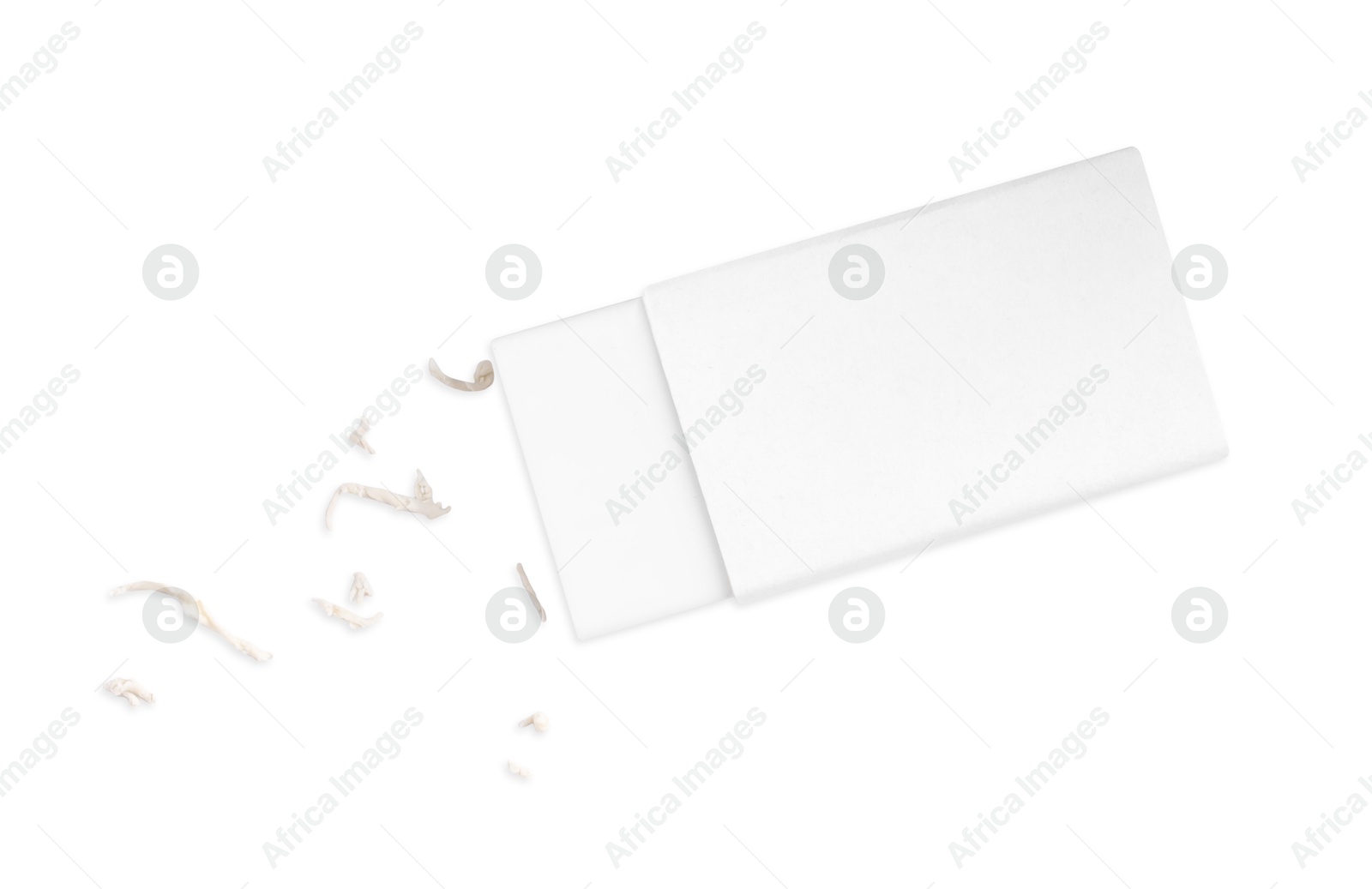 Photo of One eraser and scraps isolated on white, top view